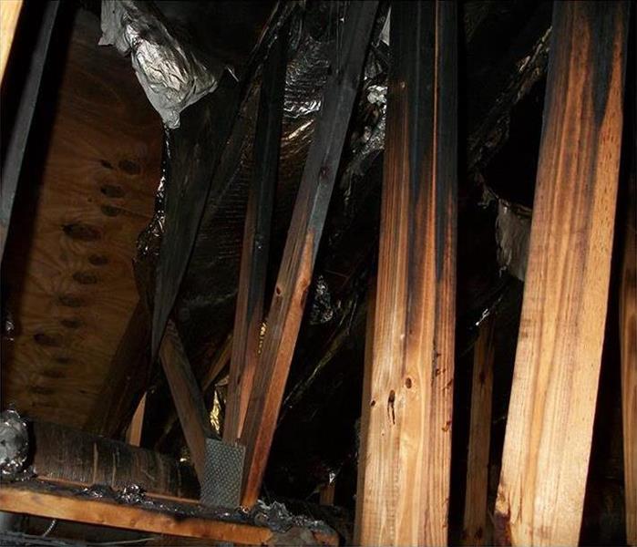 burned trusses in an attic crawlspace